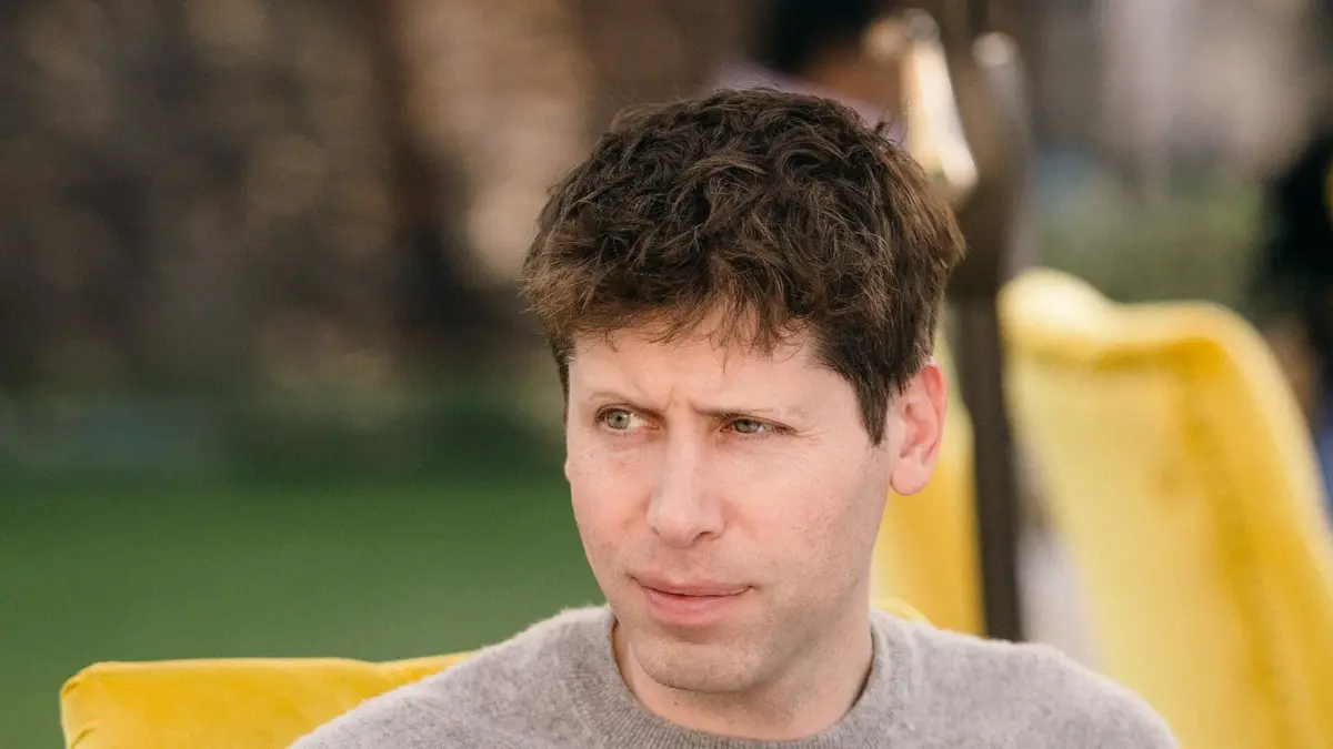 Sam Altman seated at an outdoor table